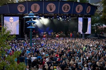 Image of concert area with crowds in front of the stage